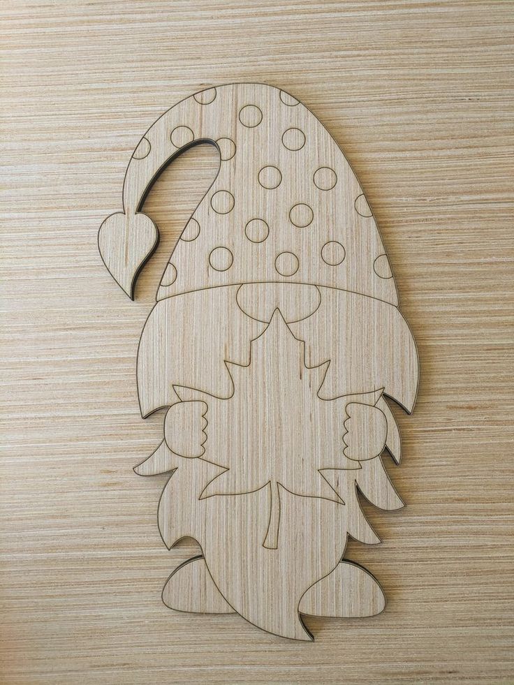 a wooden cutout of a hedgehog with polka dots on it's hat