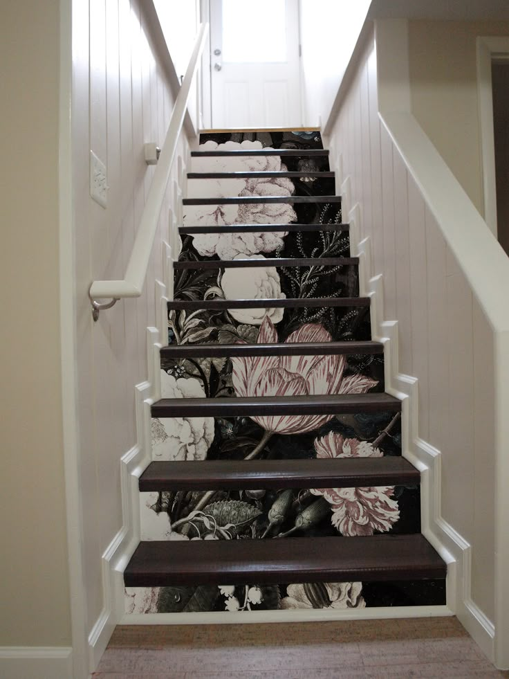 the stairs are decorated with floral wallpaper