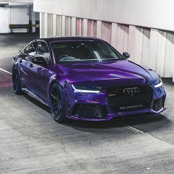 a purple sports car parked in a parking garage