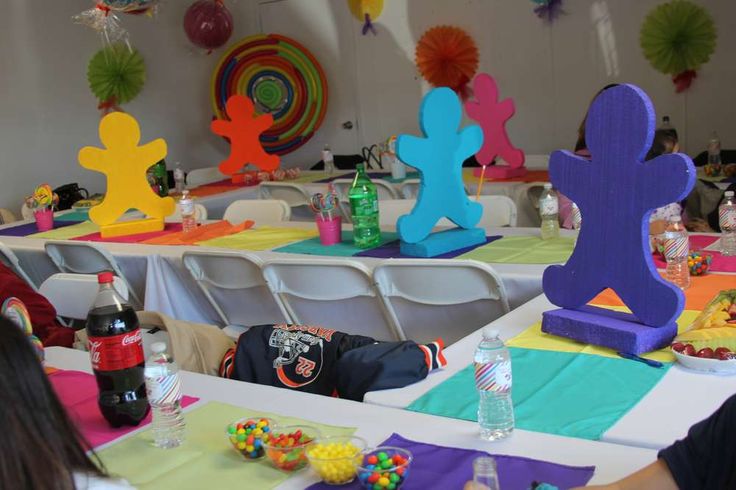 people sitting at tables with colorful decorations on them