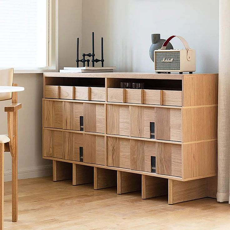 a wooden cabinet with drawers in a room