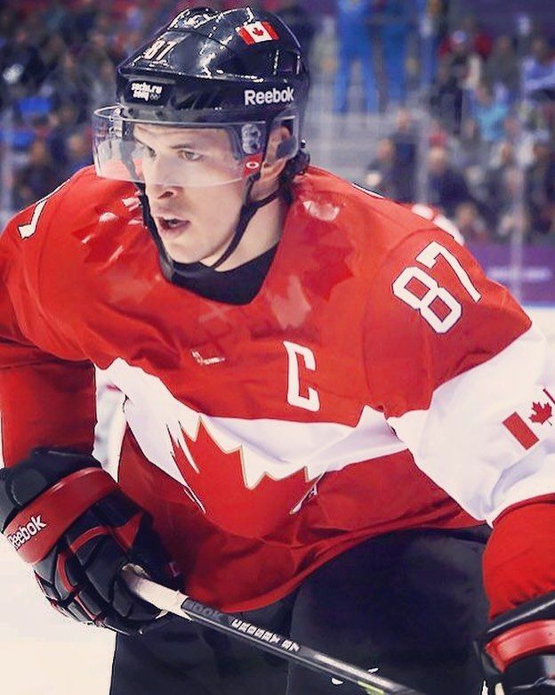 a hockey player in red and white uniform on the ice