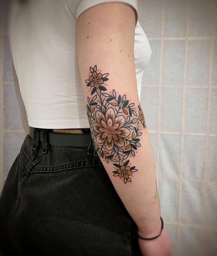 a woman with a flower tattoo on her arm