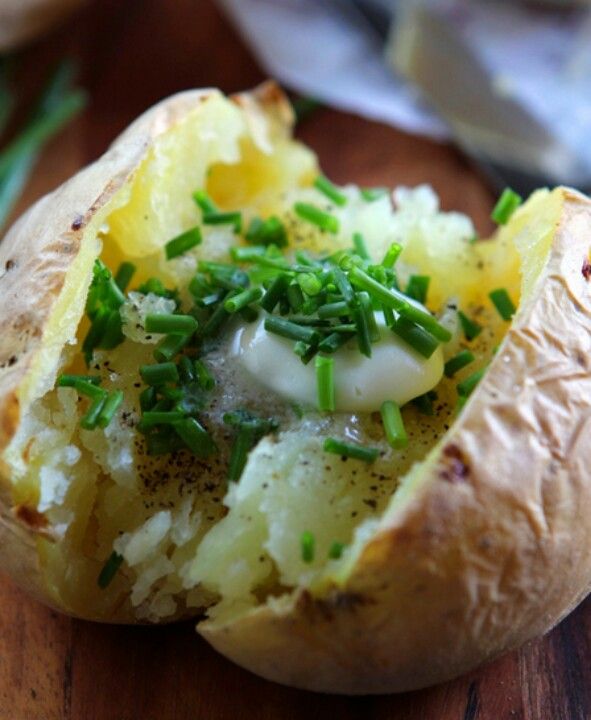 a baked potato with sour cream and chives