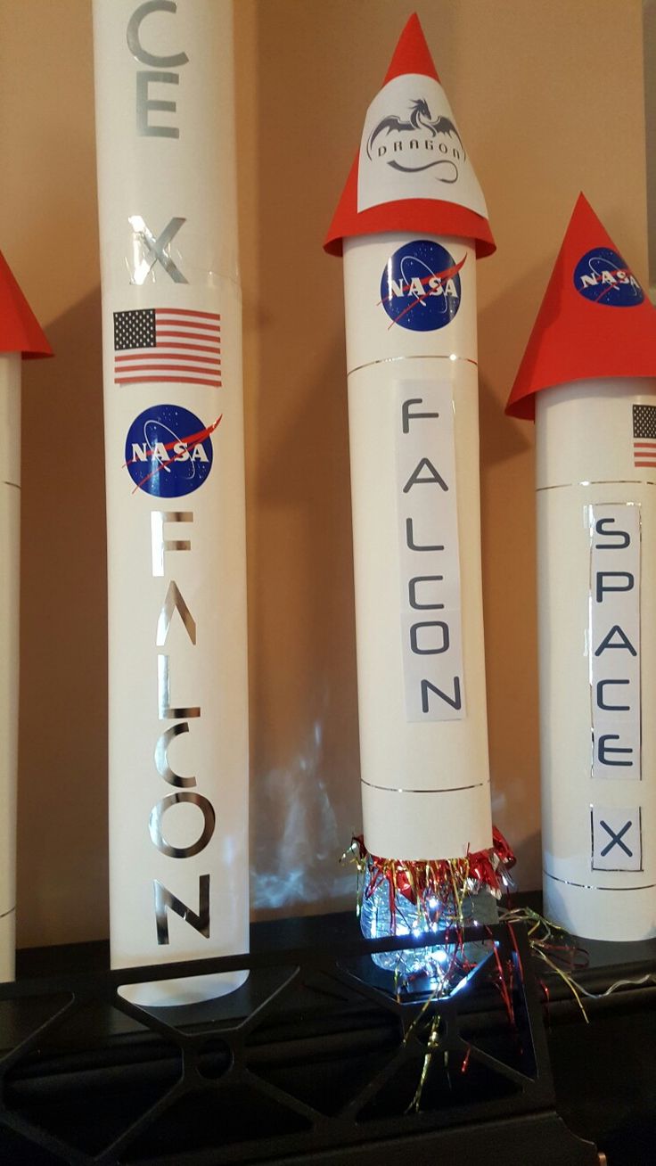 three nasa rockets sitting on top of a counter