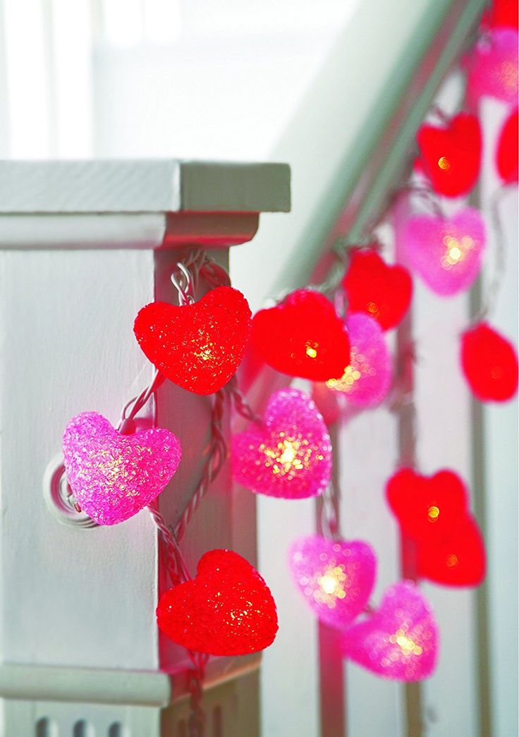 heart shaped string lights hanging from the banister