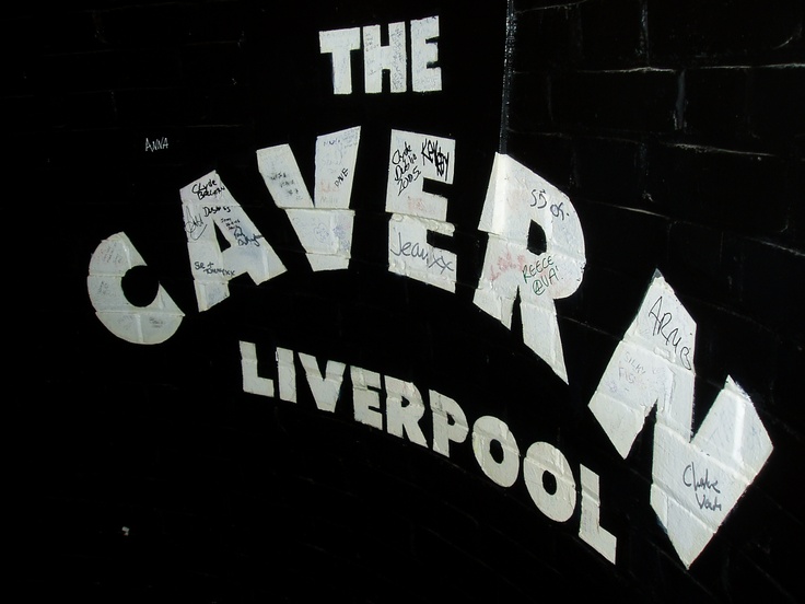 the caver liverpool sign with graffiti on it's side wall in black and white