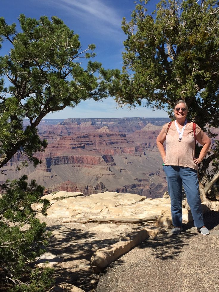 a woman standing on the edge of a cliff