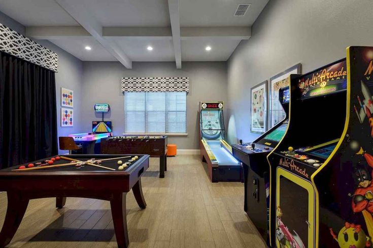 a room filled with arcade machines and tables