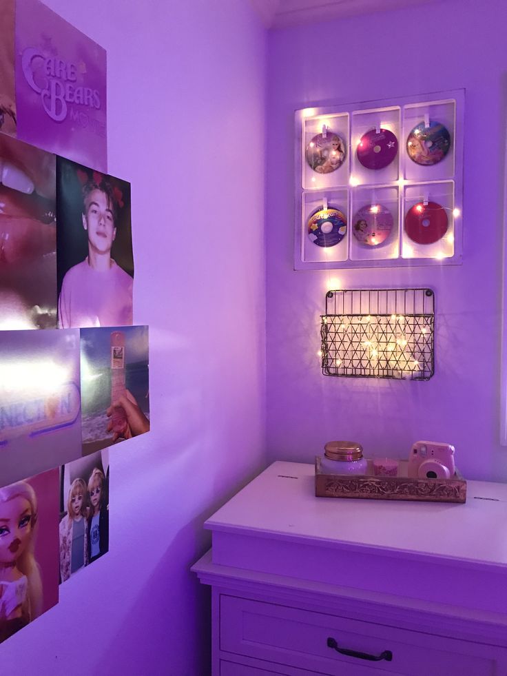 a room with purple walls and pictures on the wall