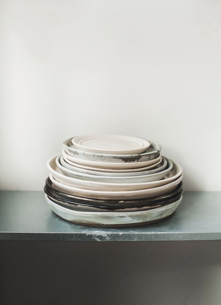 a stack of plates sitting on top of a table