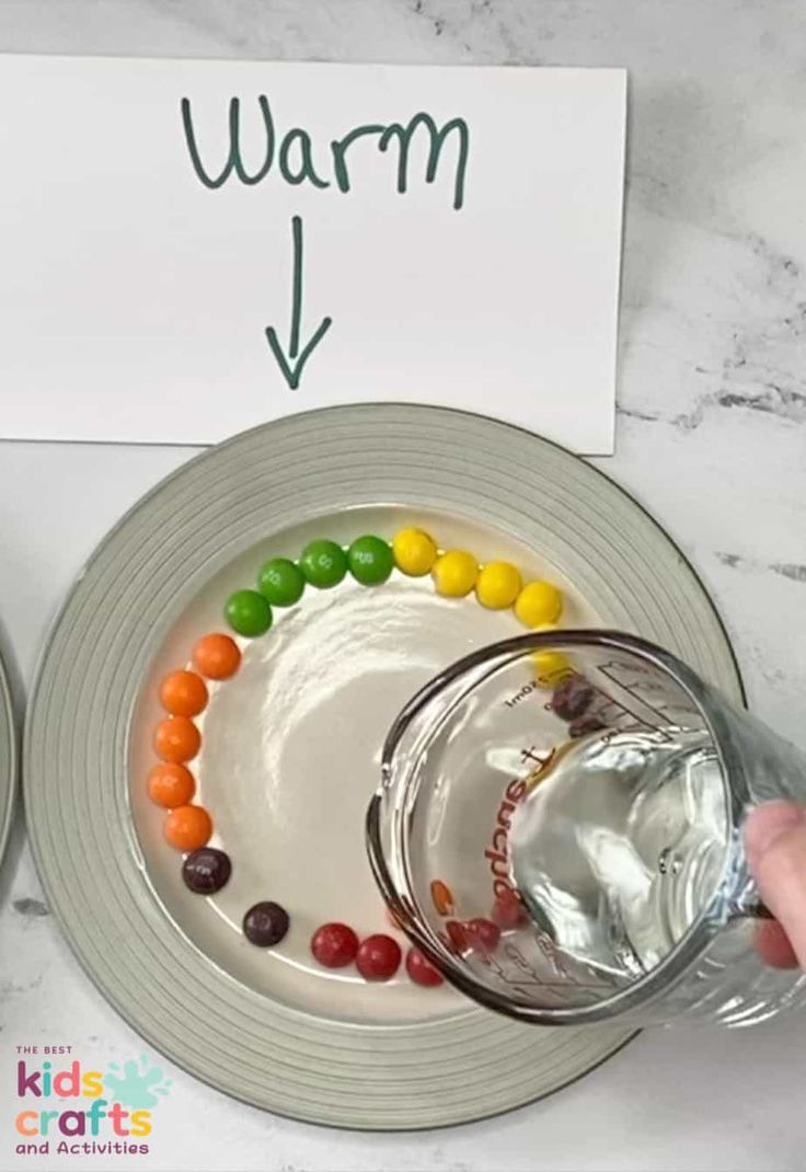 a plate with candy on it next to a sign that says warm water and jelly beans