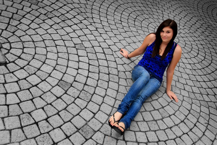 a woman sitting on the ground with her legs crossed