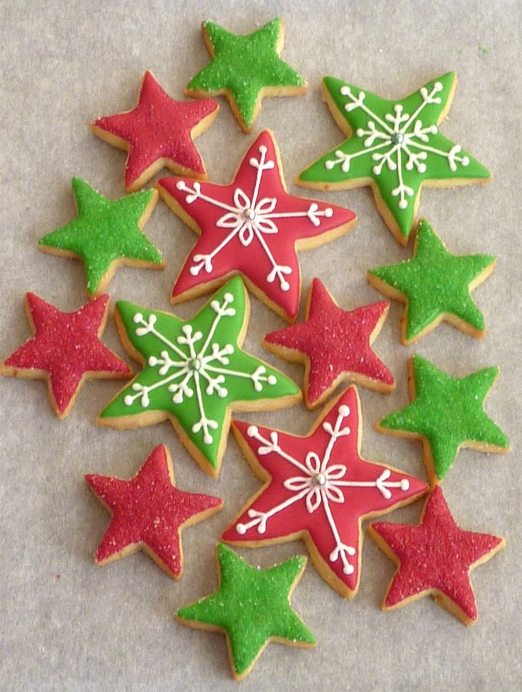 decorated christmas cookies arranged in the shape of stars