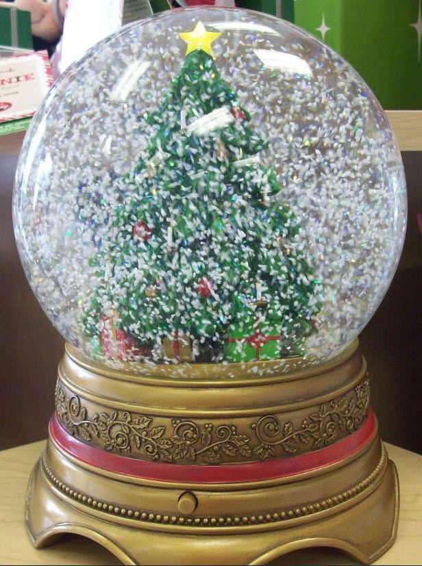 a snow globe with a christmas tree inside