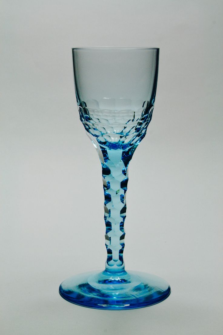 a blue wine glass sitting on top of a table