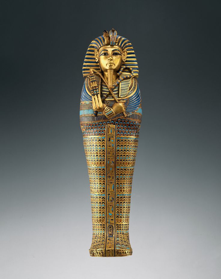 an egyptian statue is shown in gold and blue with intricate designs on it's body