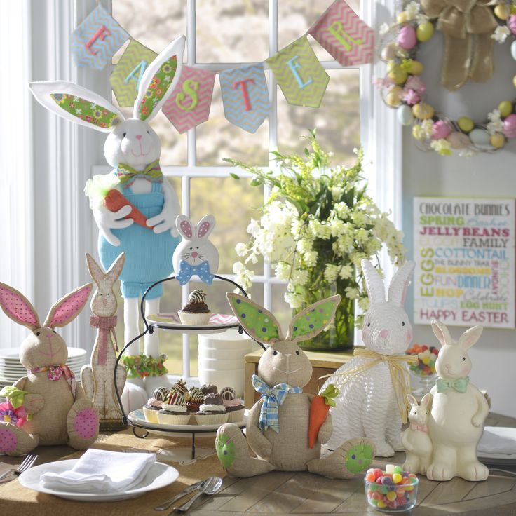 a table topped with bunnies and bunny figurines