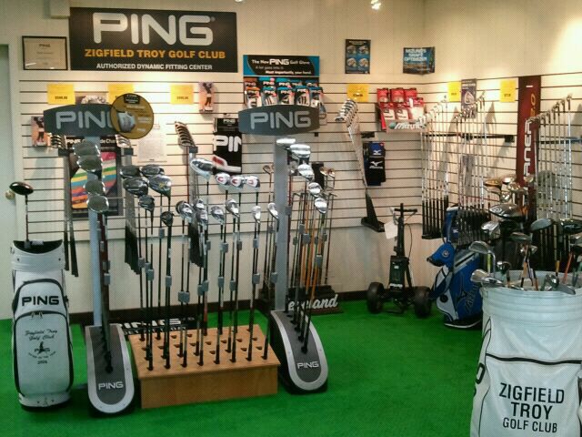 the inside of a golf shop filled with lots of different types of clubs and equipment