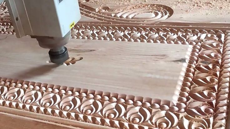 the machine is making decorative tiles on the floor in the room that looks like it's made out of wood