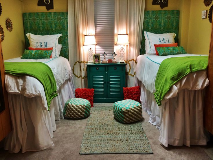 two twin beds in a bedroom with green headboards