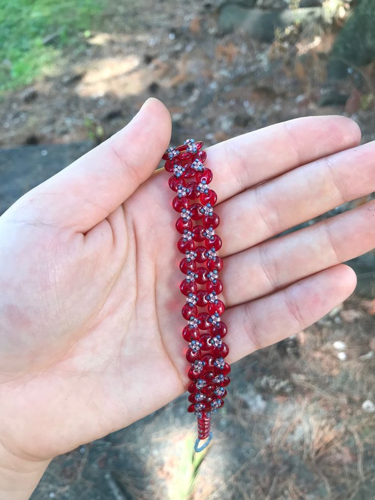 Opaque Red handmade lentil bracelet. I stitched this bracelet using a needle and fireline beading thread. It is made with red two hole lentil beads and size 15 seed beads. This bracelet is 7 and 3/4 inches long and 1/2 an inch wide. Metal free, and perfect for people with allergies to copper, iron, gold, or silver! :)   Materials *czech beads *fireline  *seed beads (size 15) *two hole lentil beads  Feel free to message me with any questions about this product Red Crystal Bracelet With Spacer Beads, Handmade Red Crystal Bracelet With Round Beads, Red Bohemian Crystal Bracelet With Round Beads, Festival Red Beaded Braided Bracelets, Bohemian Red Crystal Bracelet With Round Beads, Red Beaded Bracelets With Spacer Beads For Festival, Handmade Adjustable Beaded Bracelets With Oval Beads, Red Beaded Bracelets For Crafting, Festival Red Beaded Bracelets With Spacer Beads