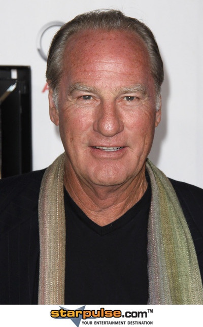 an older man wearing a black shirt and scarf