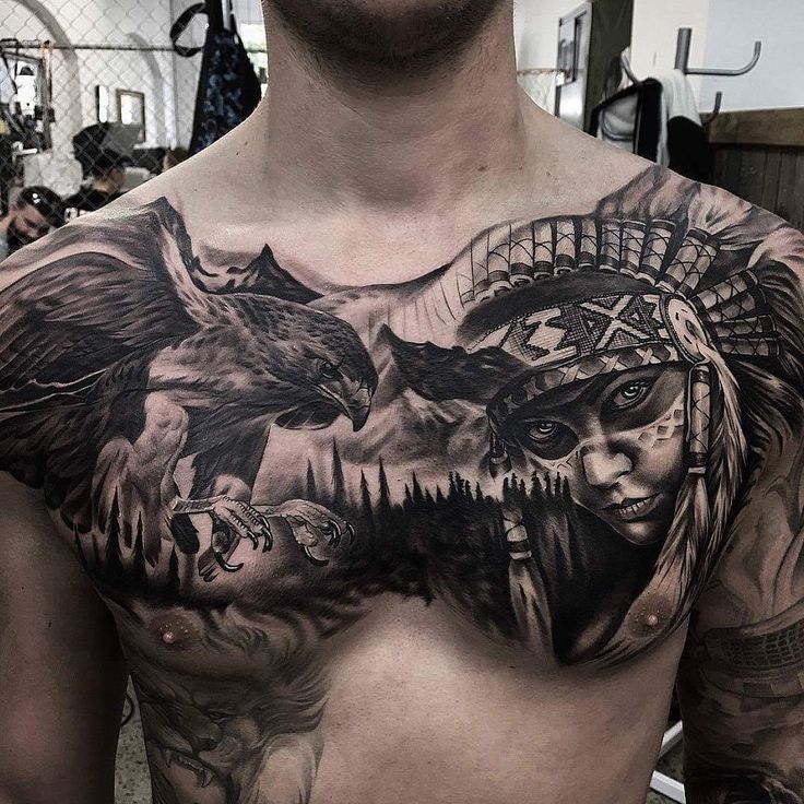 a man's chest with an eagle and native american tattoos on his left side