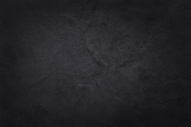 a black background that looks like it has been made out of cement or concrete blocks