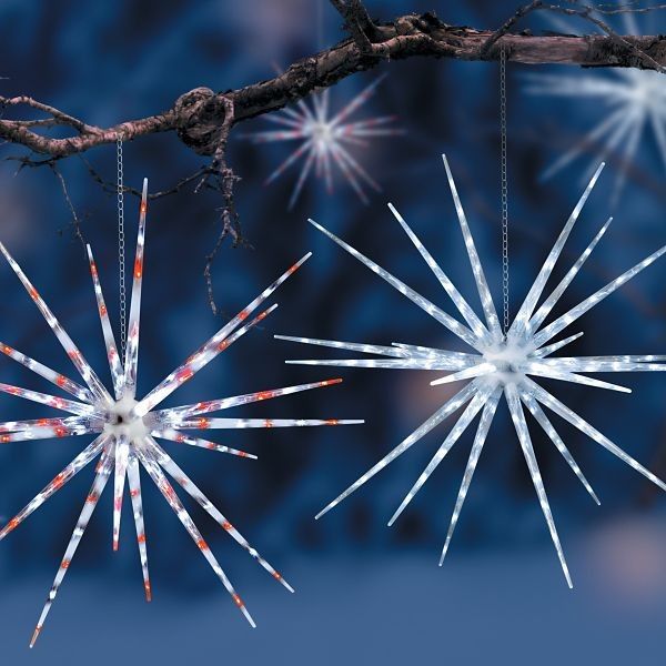 three snowflakes hanging from a tree branch