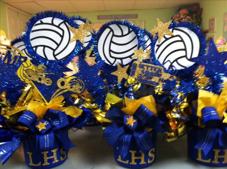 blue and gold decorations with volleyballs on them