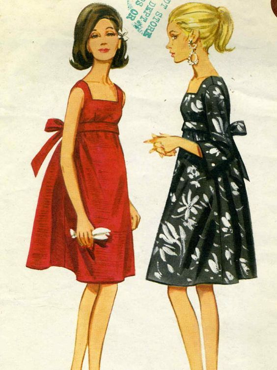 two women in dresses standing next to each other with their hands on their hipss