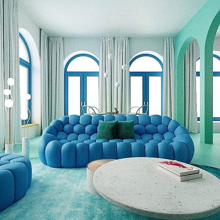 a living room filled with blue couches and round tables in front of large windows