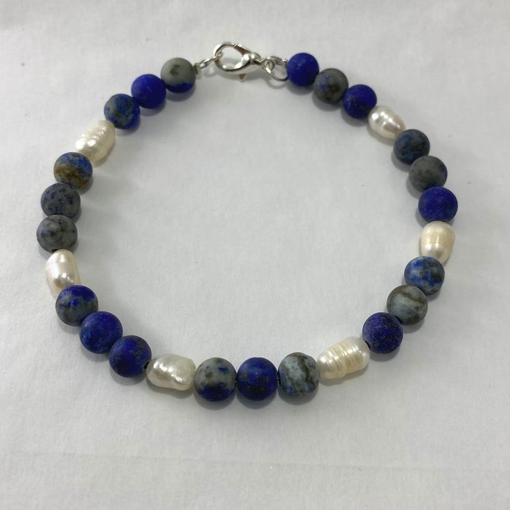 "🌸 Sign up for the Starfish by Kristan email list and get 15% off your order NOW! https://mailchi.mp/13833f6189a3/new-customers 🌸 Looking for high quality, affordable jewelry?  If so, this bracelet is for you!  This gorgeous lapis lazuli and freshwater pearl bracelet is perfect in any setting!  Each bead in this bracelet is hand selected and strung with high quality tarnish free silver beading wire to ensure the best quality. Lapis lazuli has been associated with strength and courage, royalty and wisdom, intellect and truth.  Hypoallergenic.   OUR BRACELETS ARE... *Made with high quality lava stones, semi-precious beads, silver, and glass beads *Tarnish free silver wire & gold wire, 925 silver, 1mm stretch cord, waxed linen cord *Crafted in house *Available in one size 7.5\" CARE INSTRUC Blue Gemstone Bracelet, Lapis Lazuli Bracelet, Precious Beads, Freshwater Pearl Bracelet, Semi Precious Beads, Delray Beach, Bracelet Blue, Beading Wire, Affordable Jewelry