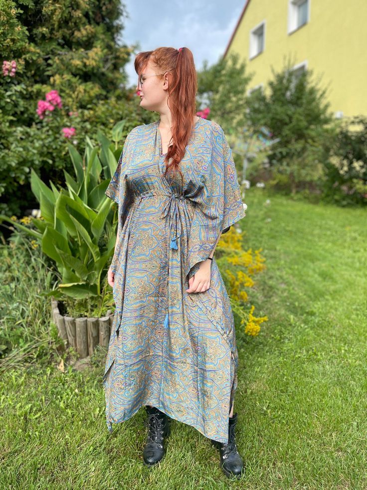 Our handmade  kaftan is made of high quality soft Indian silk blend printed with beautiful abstract and floral print. This garment is perfect for any type of occasion. From day on the beach, to an evening dinner or even a cocktail party, Thanks to its strap it is possible to adapt it to any type of body and size. It can be worn  unfastened  as a tunic or by tightening the belt it takes shape on your body becoming a stunning dress.  The best choice to impress, you'll look divinely beautiful in this boho chic dress. A must have for every bohemian queen. Length 51 inches 70% Silk 30% Viscose ONE SIZE FITS ALL! Bohemian V-neck Printed Kaftan, Bohemian Silk Tunic With Floral Print, Silk Bohemian Tunic With Floral Print, Printed Maxi Length Kimono For Festivals, Hippie V-neck Free Size Kaftan, Bohemian Maxi Kaftan With Floral Print, Bohemian Silk Kimono, Bohemian Printed Maxi Length Kimono, Bohemian Silk Flowy Kimono