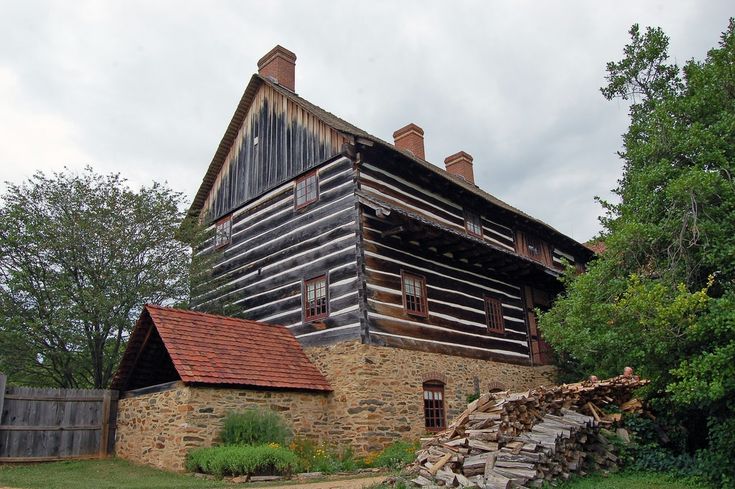 an old log cabin sits in the woods