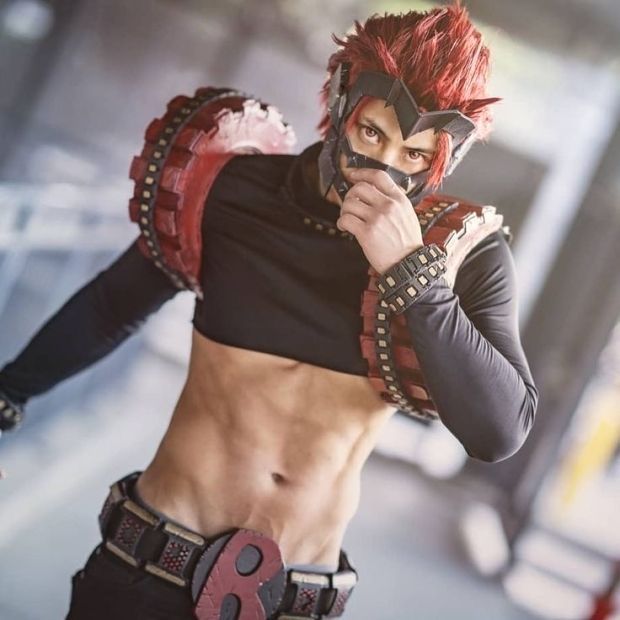 a man with red hair and no shirt is posing for the camera wearing a mask