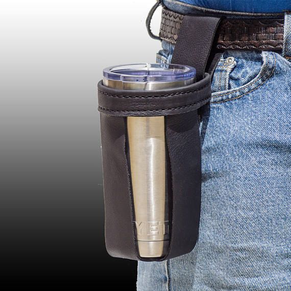 a person wearing jeans and holding a coffee cup in their back pocket with a leather belt around his waist