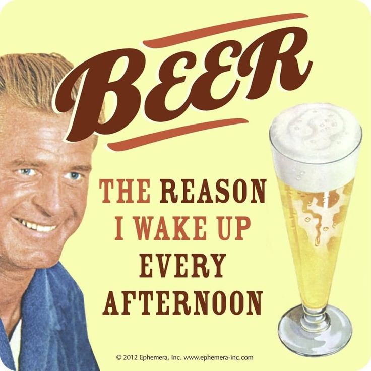 a man is smiling next to a beer sign