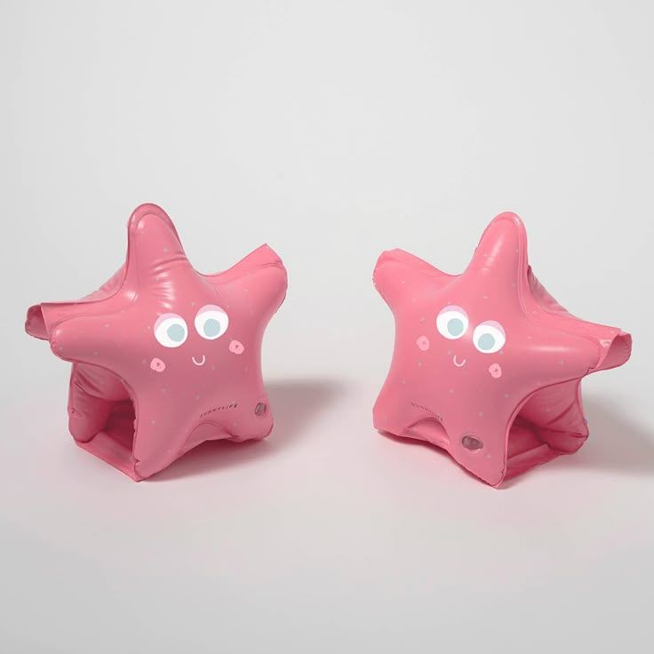 two pink plastic starfishs with googly eyes