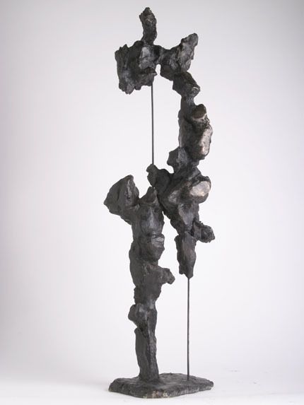 a sculpture made out of rocks on a white background