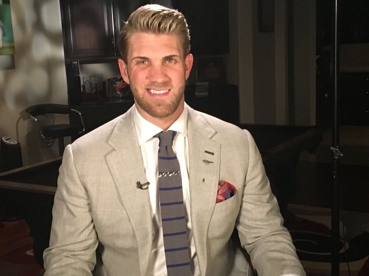 a man in a suit and tie sitting down