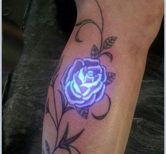 a tattoo with a blue rose on it