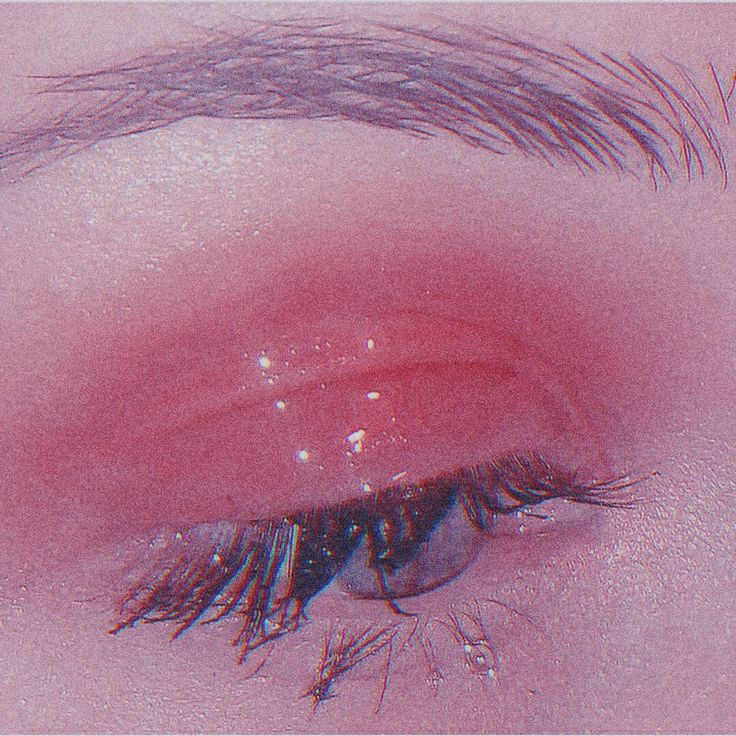 an eye with long lashes and pink background