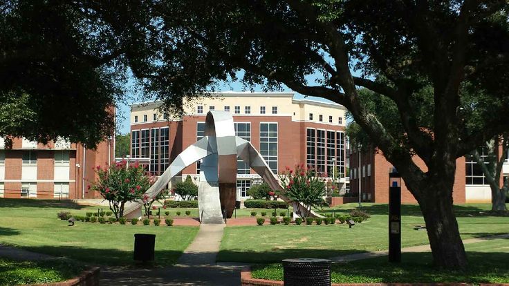 a large metal sculpture in front of a building