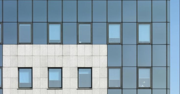 the side of an office building with many windows