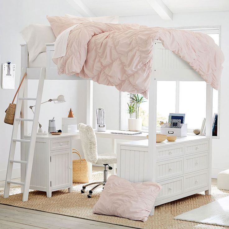 a white loft bed with pink comforter and pillows on the bottom bunk, in a bedroom