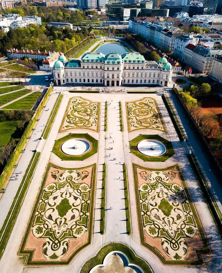 an aerial view of a large building in the middle of a park with lots of trees