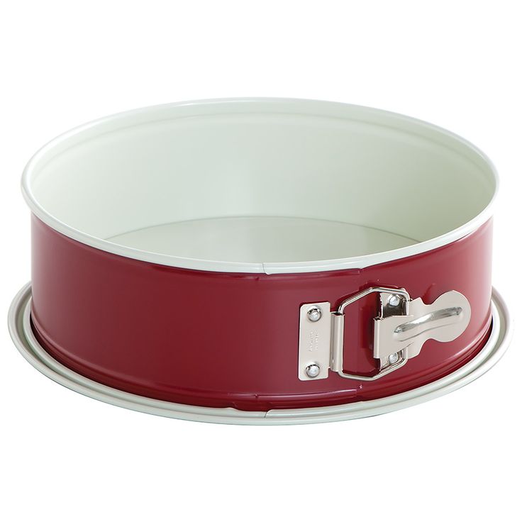 a red and white pan with two handles on the bottom is sitting in front of a white background