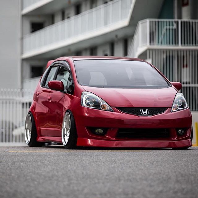 a red car parked in front of a building